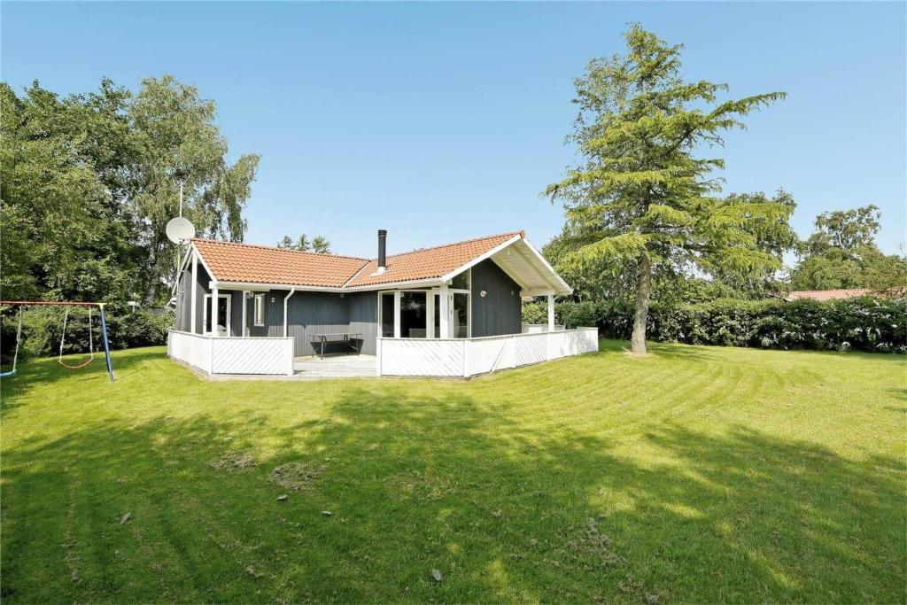 a small house in a yard with a soccer field at 30410-Odder-Hulager-2 in Odder