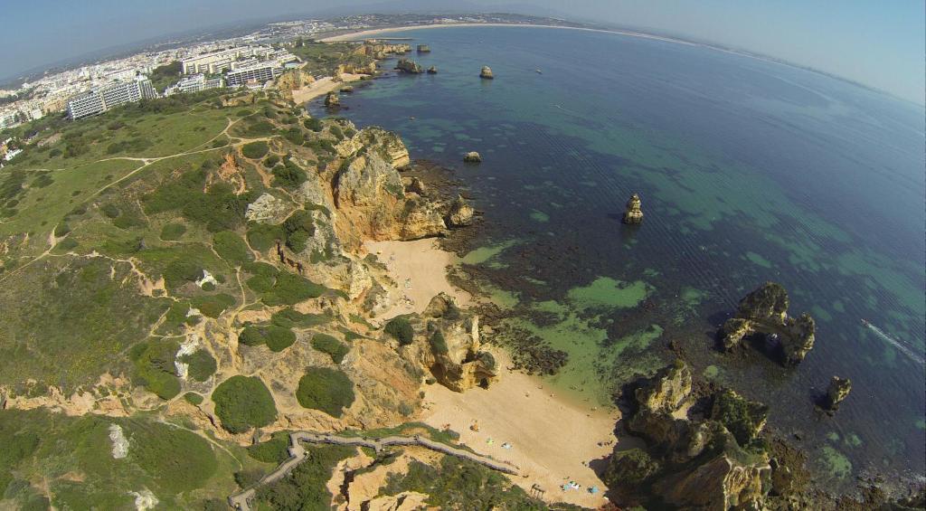 an aerial view of a rocky island in the ocean at Vilamar in Luz