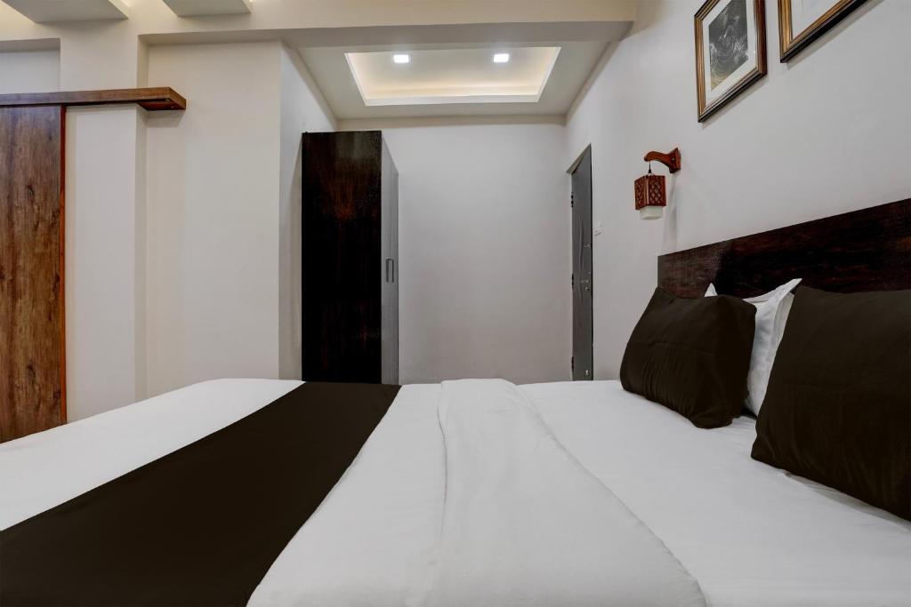 Ένα ή περισσότερα κρεβάτια σε δωμάτιο στο Super Hotel O DH