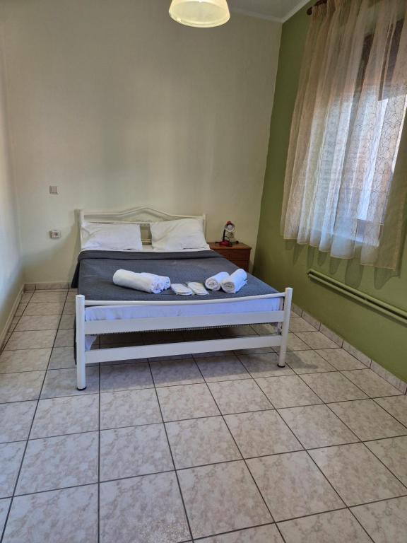 a bedroom with a bed with towels on it at Old Town Apartment in Kavala