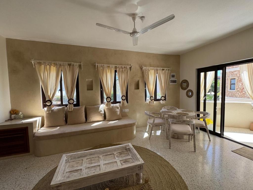a living room with a couch and a table at Casa Binti Ghepard Towers in Watamu