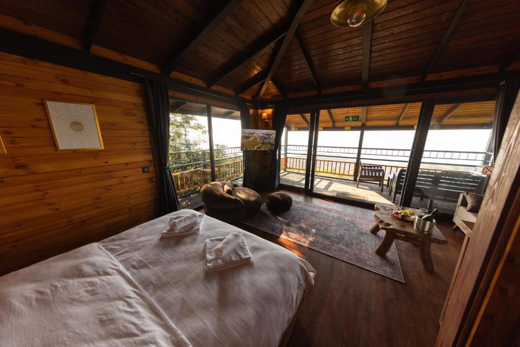 a bedroom with a bed in a room with windows at Indra Village Hotel in Pazar
