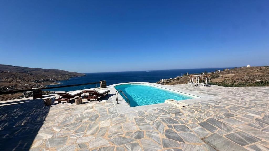 a swimming pool with a view of the ocean at Koundouros 186 View in Koundouros