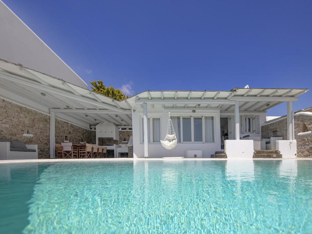 a swimming pool in front of a house at Villa in Mykonos with Sea View and Pool in Kalafatis