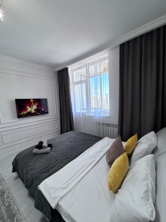 Postel nebo postele na pokoji v ubytování Апартаменты на главной улице Сыганак, рядом с Ханшатыр