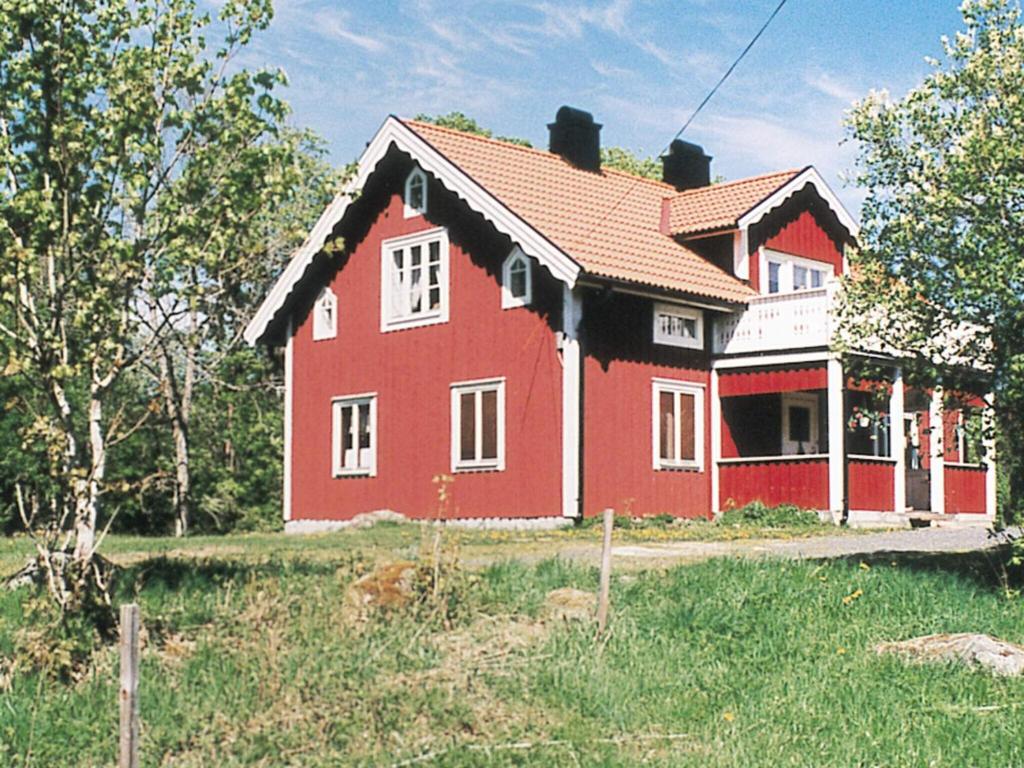 a red house in the middle of a field at 6 person holiday home in RYSSBY-By Traum in Agunnaryd