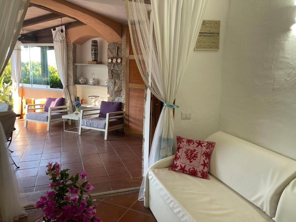 a living room with a white couch in a room at Apartment in Porto Cervo surrounded by greenery in Abbiadori