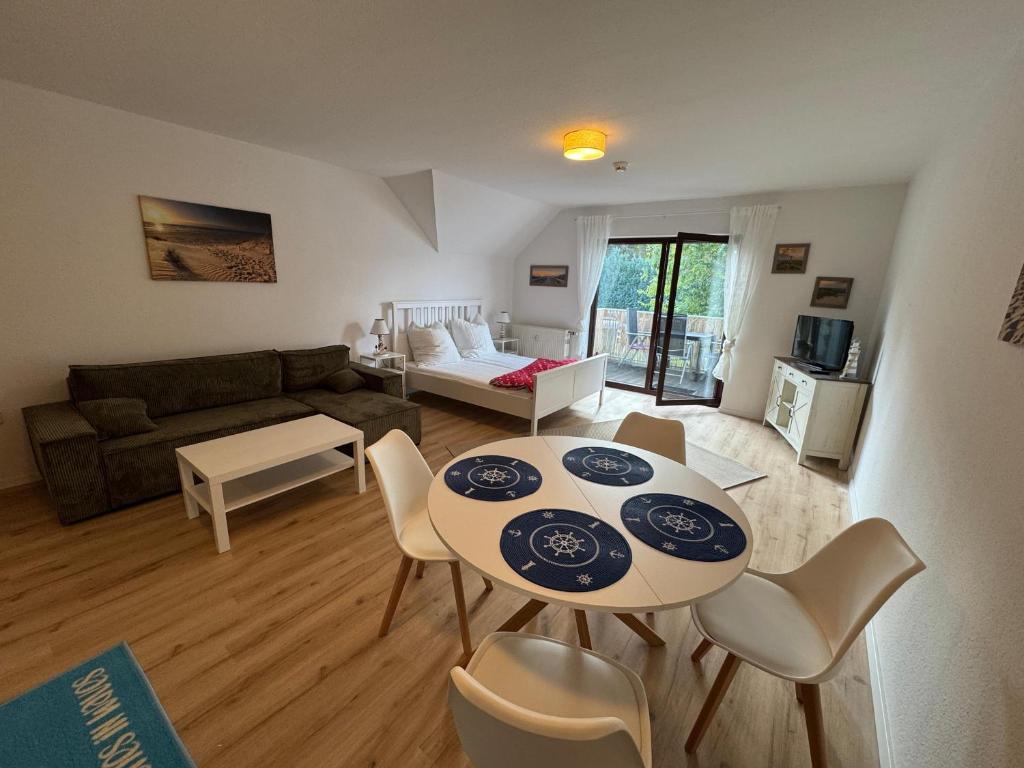 a living room with a table and chairs and a couch at Ferienwohnung mit Balkon FeWo 11 Gustow in Gustow