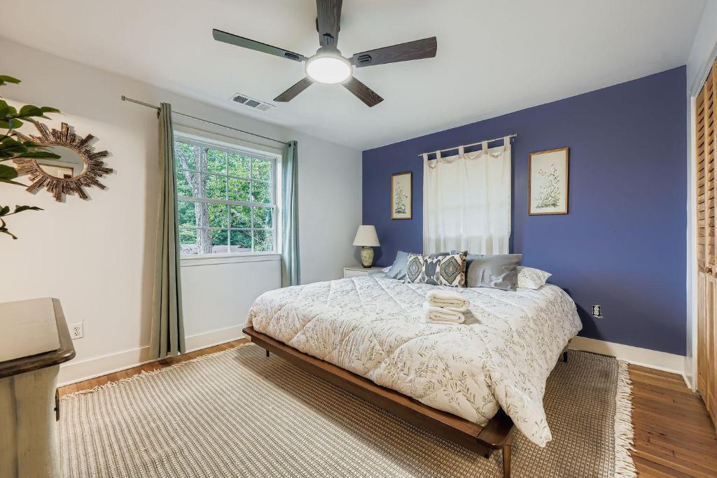 a blue bedroom with a bed and a ceiling fan at Elegant & Spacious Family Gem with Games, Office, Yard in Clarkston
