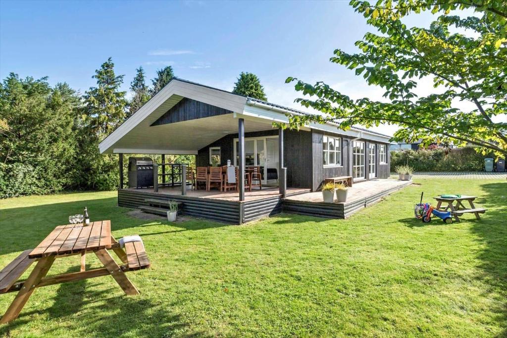 a small house with a picnic table in the yard at 30027-Malling-Peter-Eriksens-Vej-14 in Malling