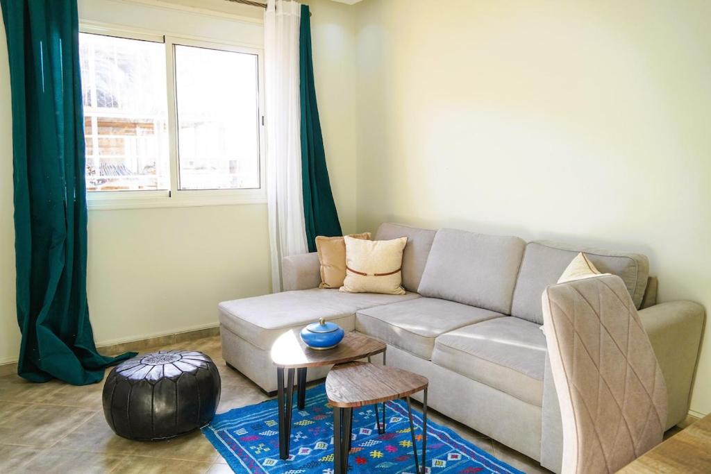 a living room with a couch and a table at Modern 2 bedroom apartment, one with terrace in Marrakech