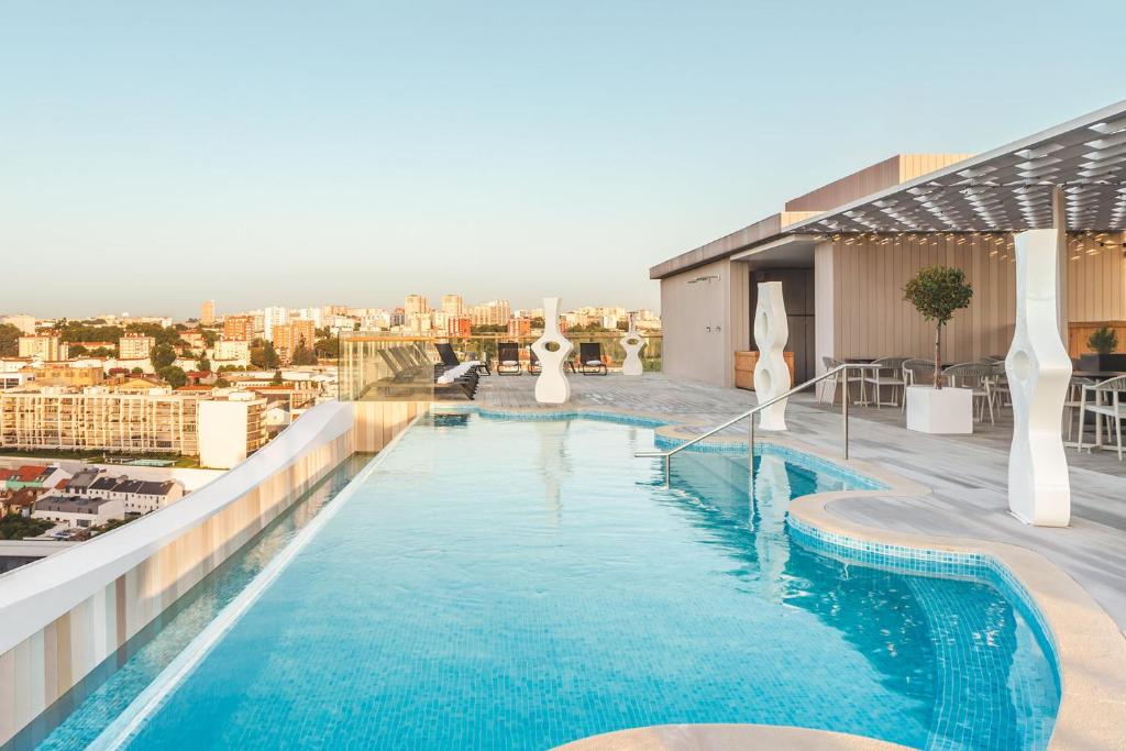 A rooftop pool with city views and a shaded deck.
