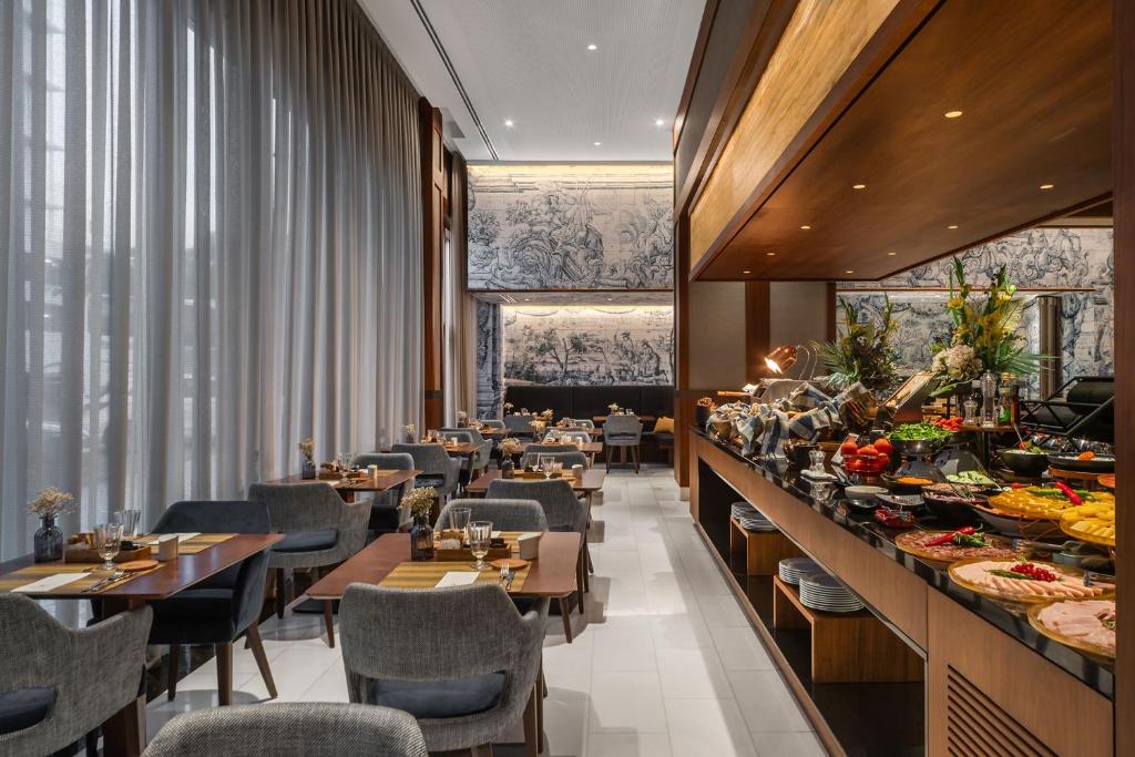 A bright breakfast room beside a generously stocked buffet.
