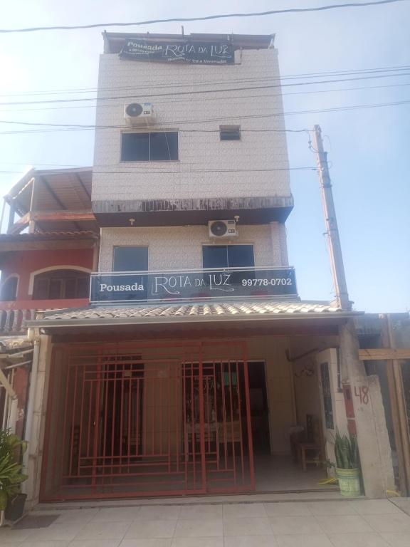 a building with a gate in front of it at Pousada Rota da Luz in Aparecida