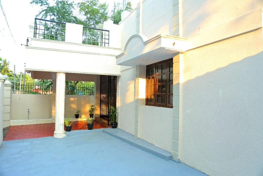 a large white building with a balcony on it at Relax inn villa 3BHK in Puducherry