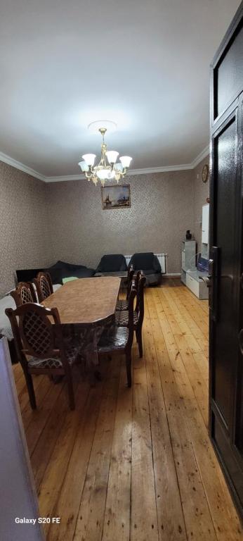 a dining room with a wooden table and chairs at Alen Apartament in Dilijan
