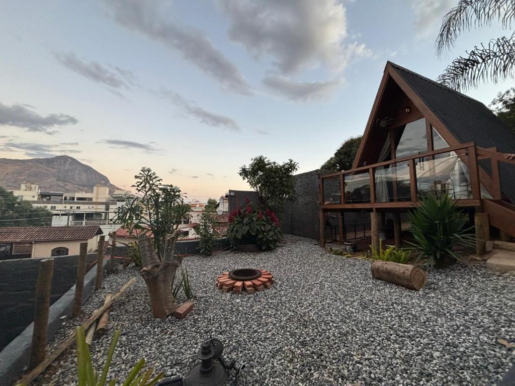 a house with a gravel yard with a building at Skychale in Governador Valadares