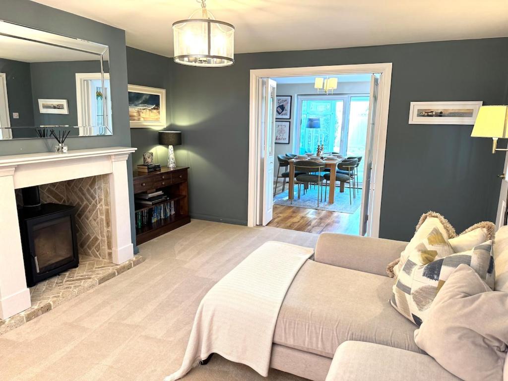 a living room with a couch and a fireplace at Seaside retreat in Mudeford in Mudeford
