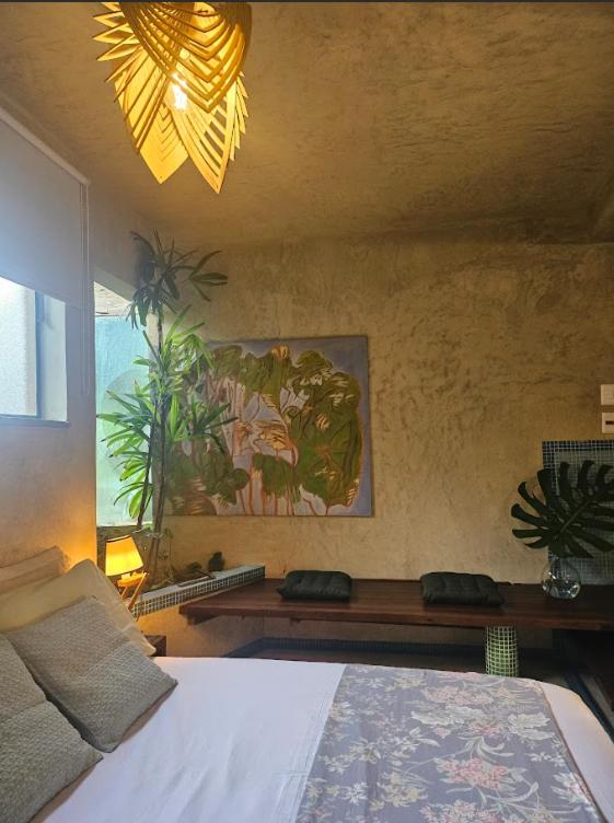 a bedroom with a bed and a painting on the wall at Espaço Spa in São Paulo