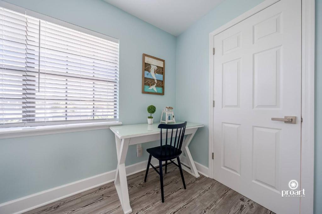 a room with a desk and a door and a chair at Mermaid's Place* 0.6 miles to beach* monthly disc in Destin