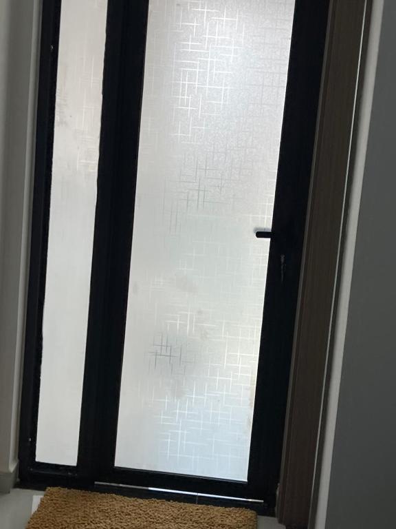 a glass window with a black frame and a rug at SamHomes in Nairobi