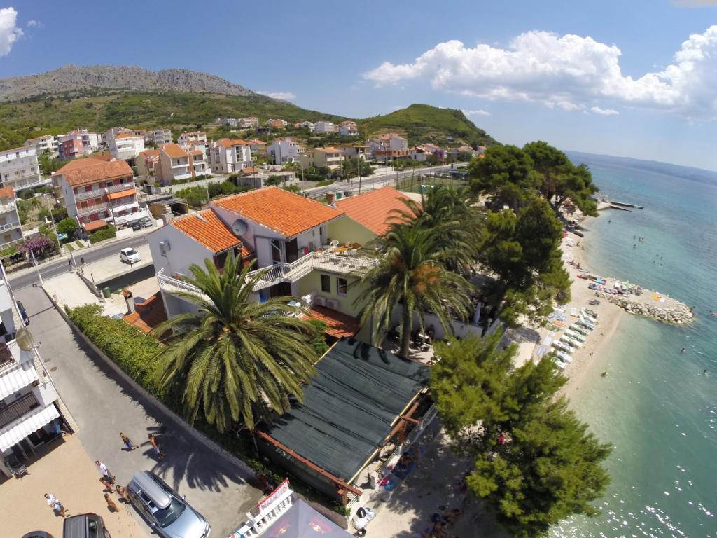 an aerial view of a beach with palm trees and buildings at Apartments & Rooms Baltazar in Podstrana