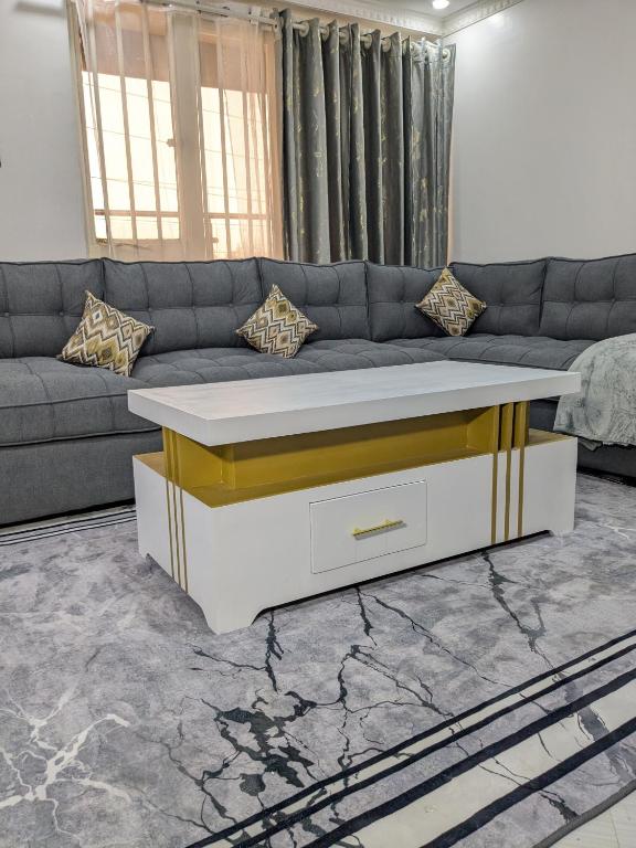 a living room with a couch and a table at 2bedroom house along waiyaki way in Nairobi