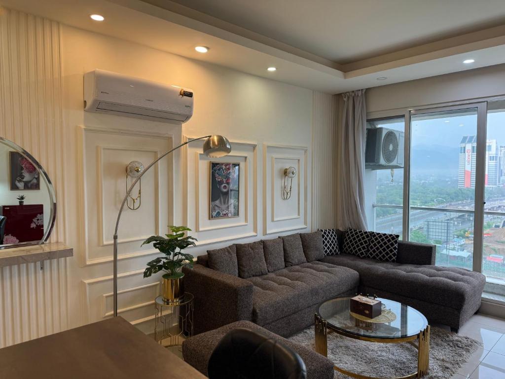 una sala de estar con un sofá y una mesa en 1 bhk at elysium downtown, en Islamabad