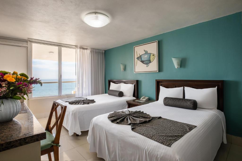 Cama o camas de una habitación en Don Pelayo Pacific Beach