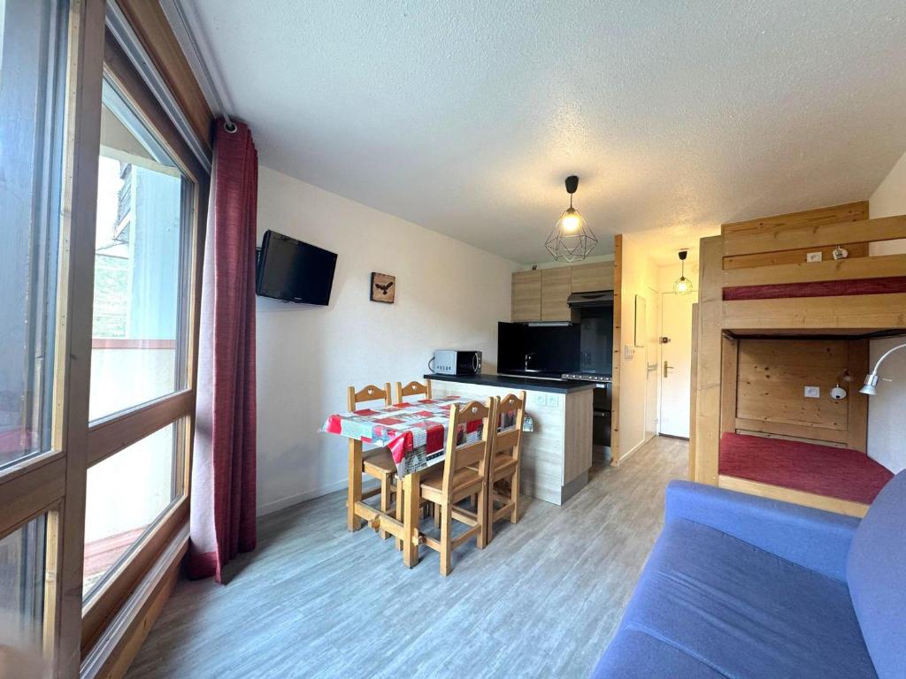 a room with a kitchen and a table with chairs at Studio lumineux avec balcon, au pied des pistes, Les Menuires – 3 personnes - FR-1-452-17 in Les Menuires