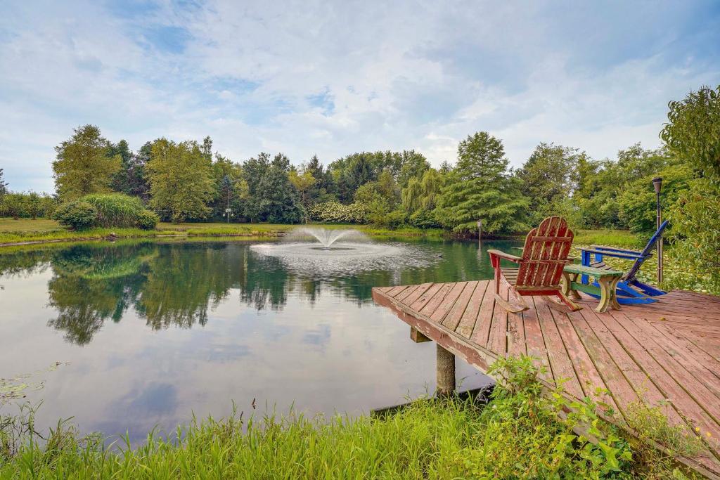 two chairs sitting on a wooden dock next to a pond at Fish, Hike and Golf Countryside Retreat in Bluffton in Bluffton