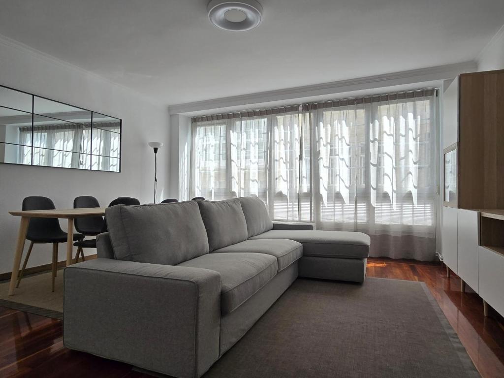 a living room with a couch and a table at Apartamento Lugo centro muralla in Lugo