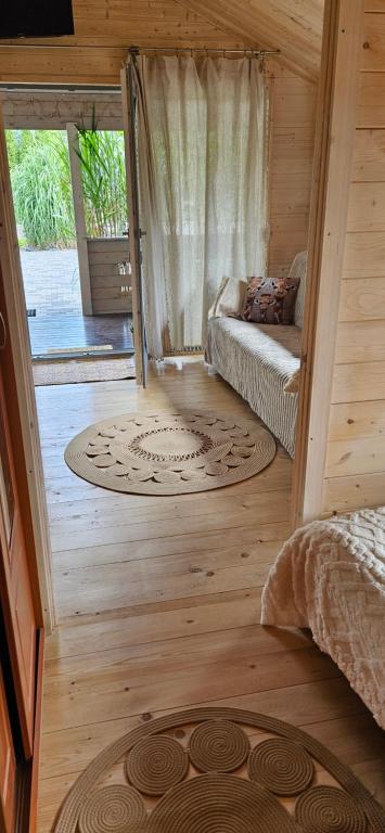 a small room with a bed and a window at Na Źródlanej in Wielgie
