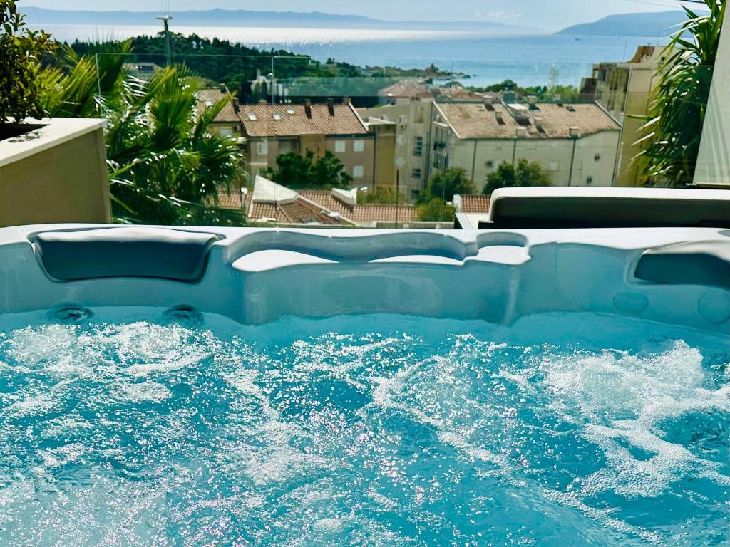 a swimming pool with water splashing in it at Luxury Adria Sea City & Whirpool, Mountain View Apartment in Makarska