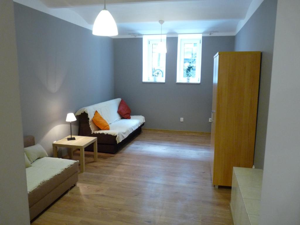 a living room with a couch and a table at Pokoje Gościnne Centrum in Krakow