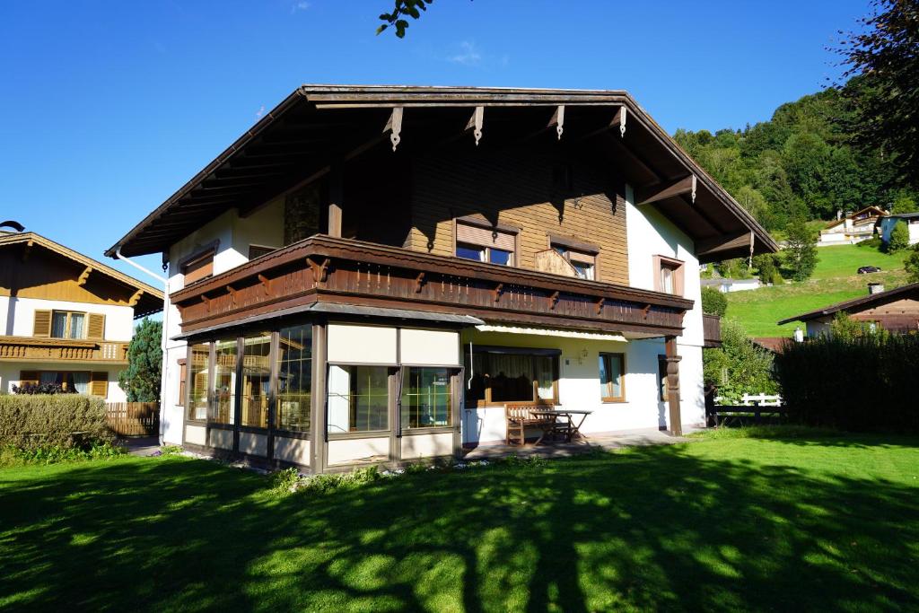 a large house with a green lawn in front of it at Panorama Appartements in Itter