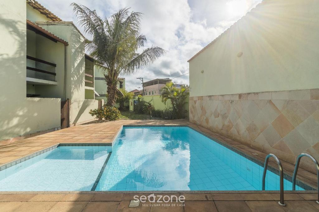 Kolam renang di atau dekat dengan Casa 4 quartos c/ Piscina e Churrasqueira NAT0202