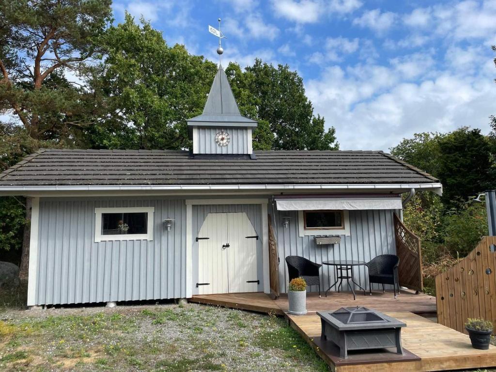 a large white shed with a white door and a tower at 4 person holiday home in Drottningskär-By Traum in Drottningskär