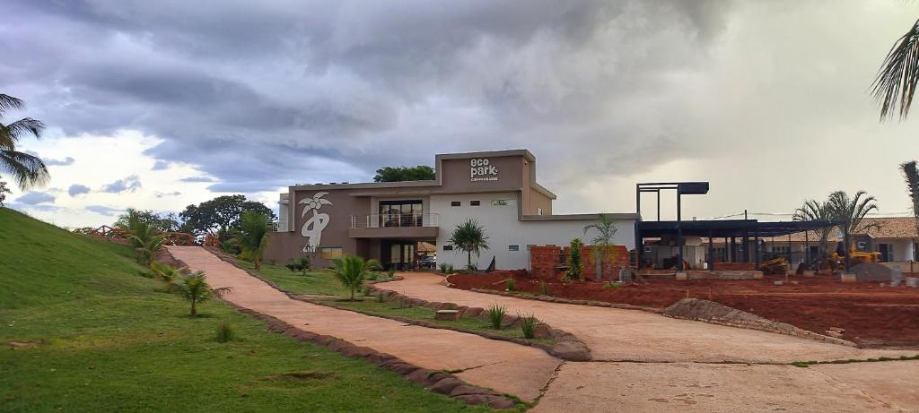 a building on a hill next to a road at Eco Park Campo Grande Hotel in Campo Grande