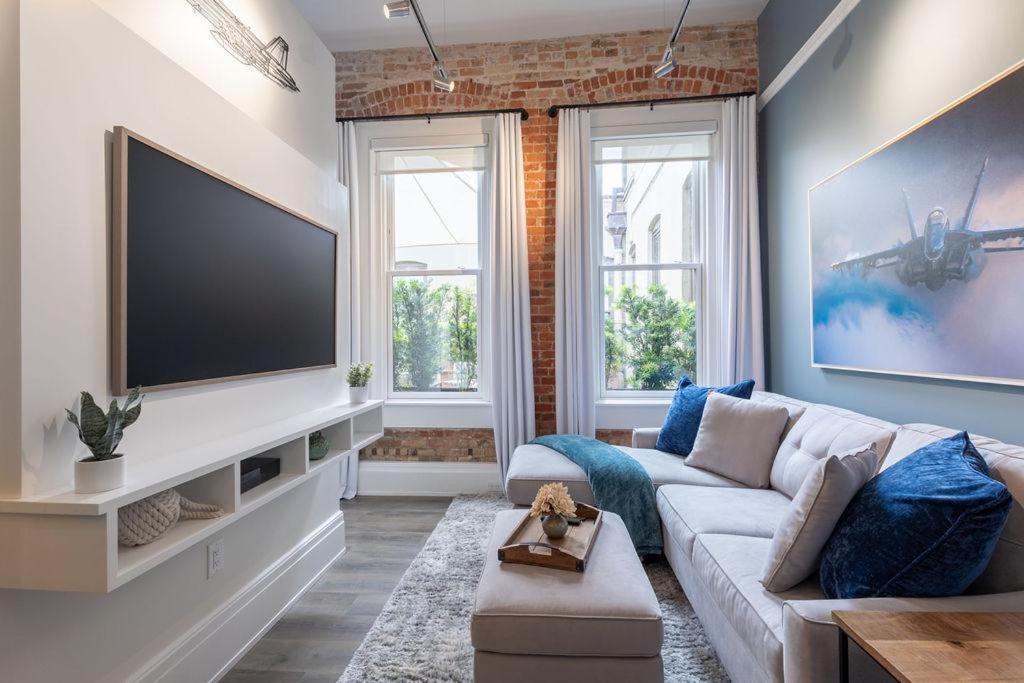 a living room with a couch and a flat screen tv at Deja Blue in Baptist Hospital Heliport