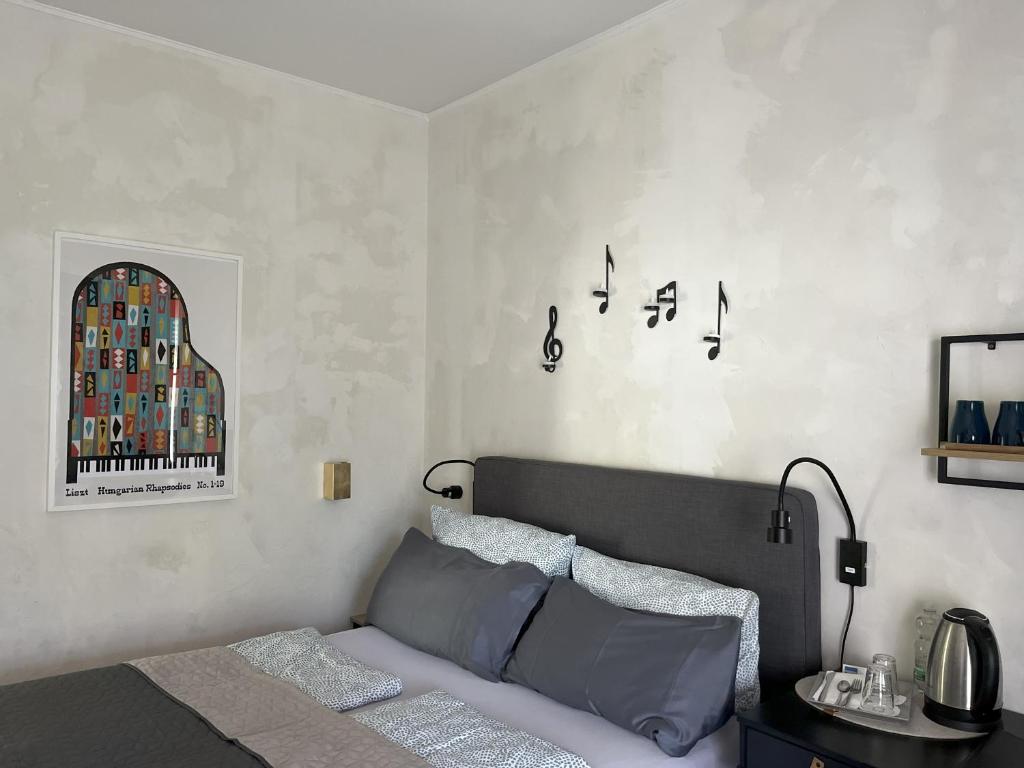 a bedroom with a bed and a wall with a window at Hotel Markgraf in Bad Bellingen