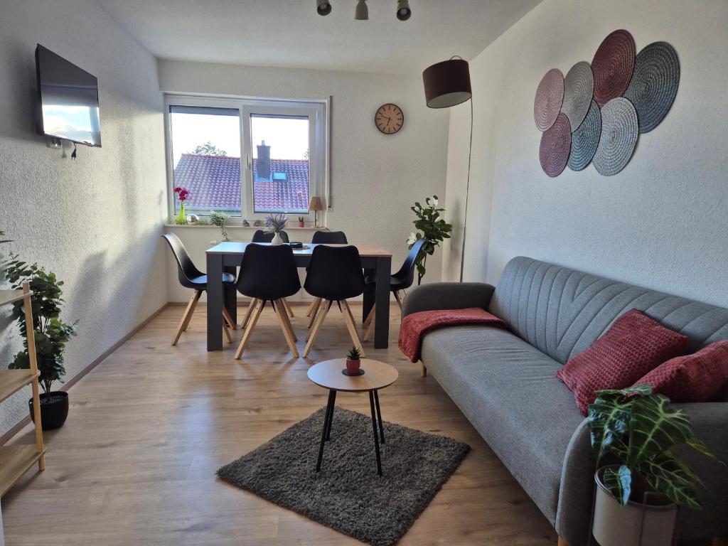 a living room with a couch and a table at Evelyns Apartment Kurpark Idylle in Bad Bocklet