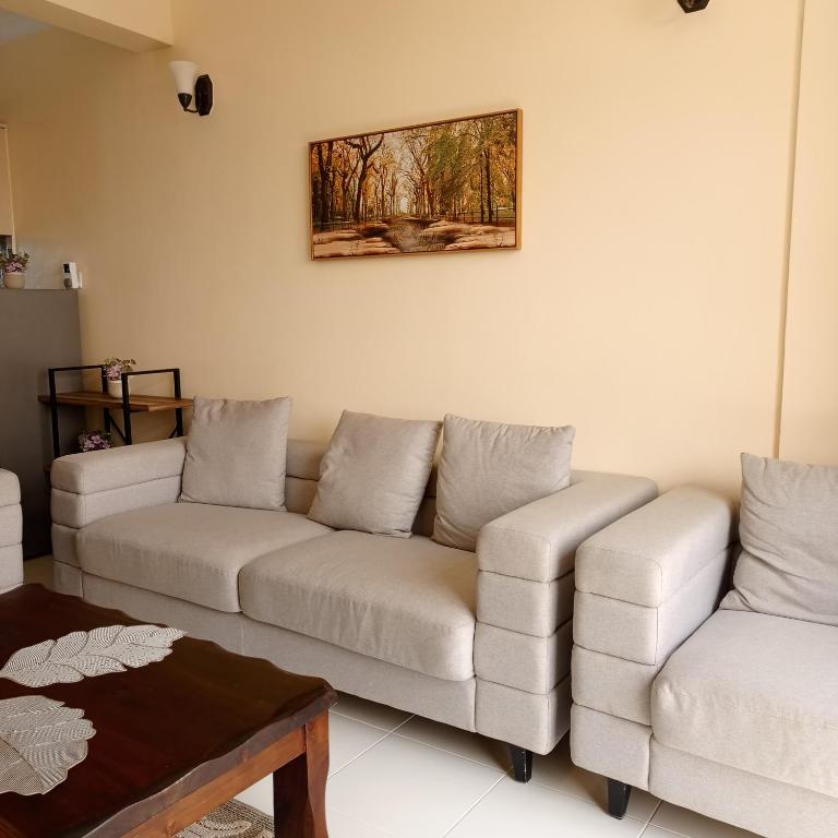 a living room with two couches and a table at Ngong Home Stays in Ngong