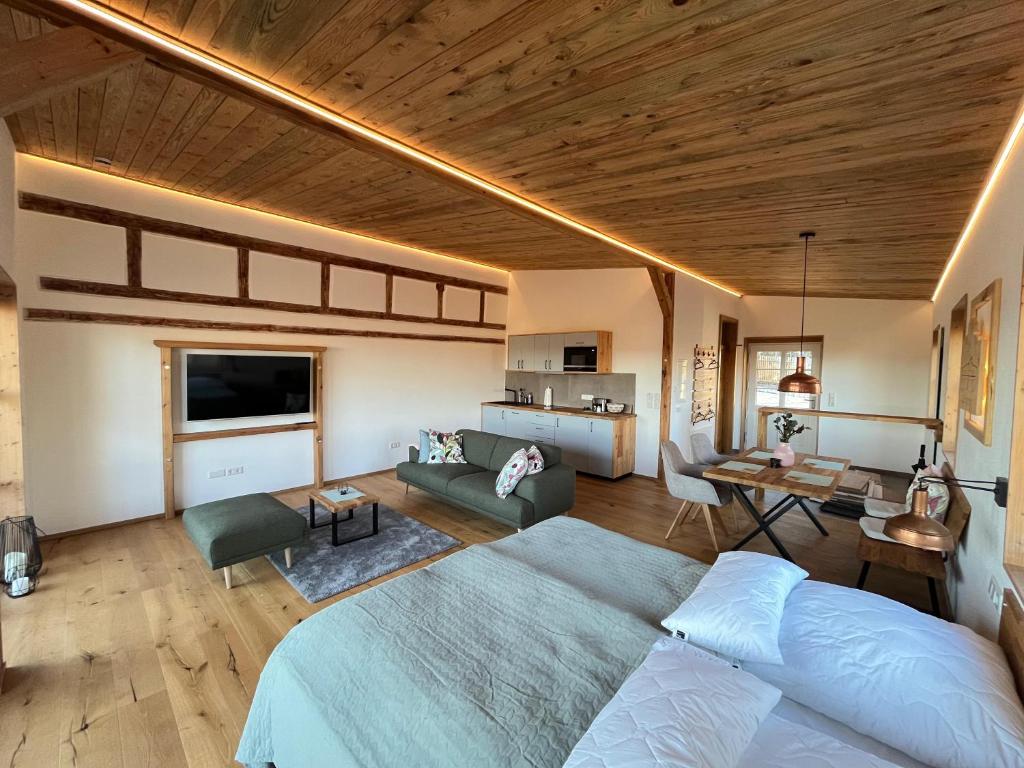 a bedroom with a bed and a living room at Weinturmsruhe in Bad Windsheim
