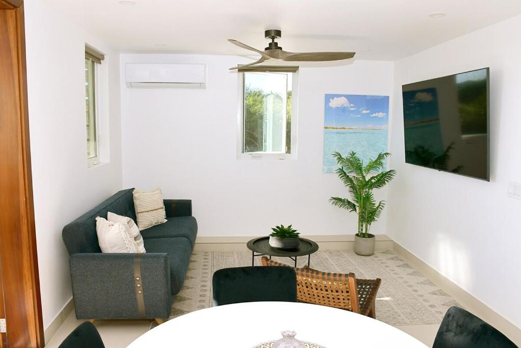 a living room with a couch and a table at Cozy 1 Bedroom Near Longbay Beach in Long Bay Hills