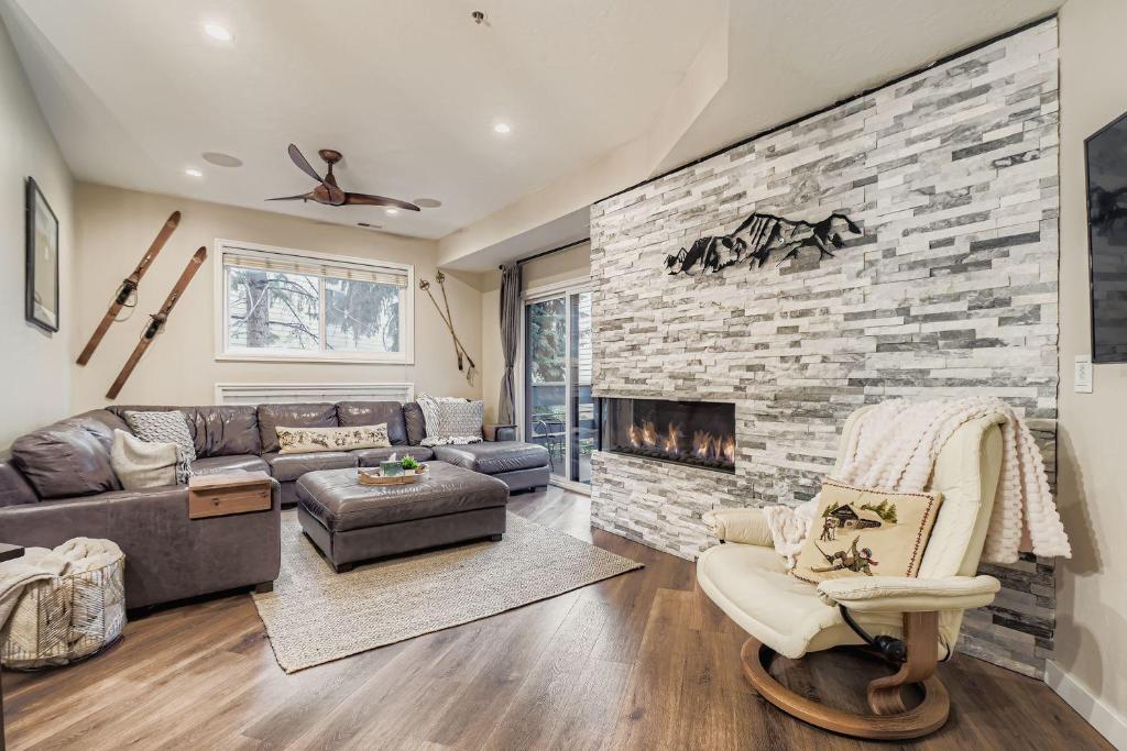 a living room with a couch and a fireplace at Peaceful Lift Line Condo 207 in Park City