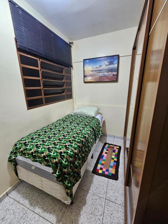 a small bedroom with a bed and a window at Studio Asa sul 7 204 in Brasilia