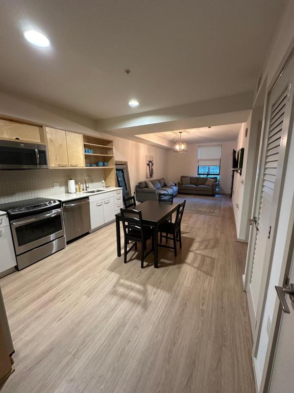 a kitchen and living room with a table and chairs at 1BR in Hollywood w patio & parking!! in Los Angeles