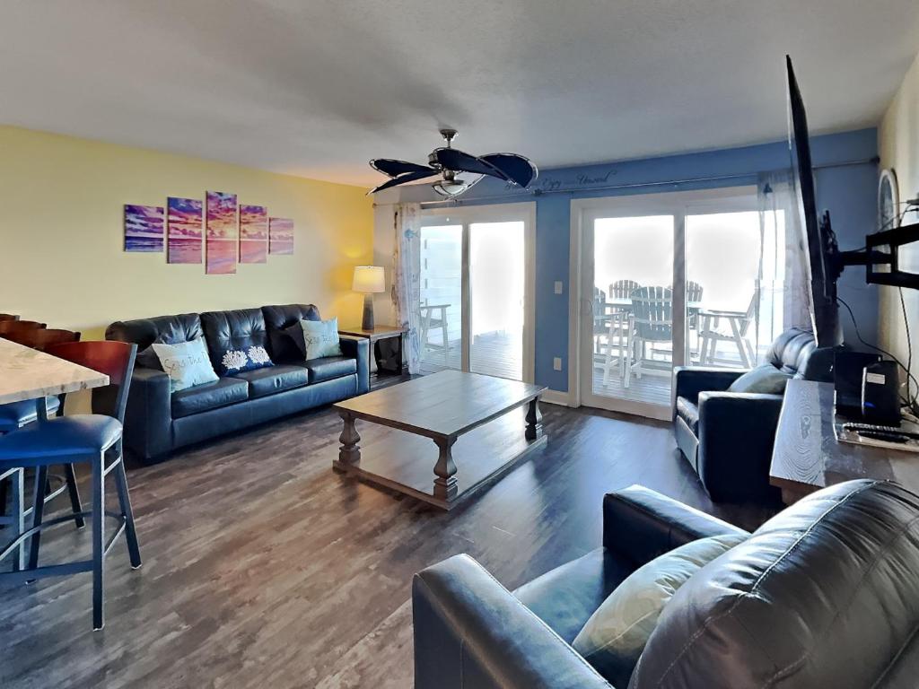 a living room with couches and a table at Put-in-Bay Waterfront Condo #103 in Put-in-Bay