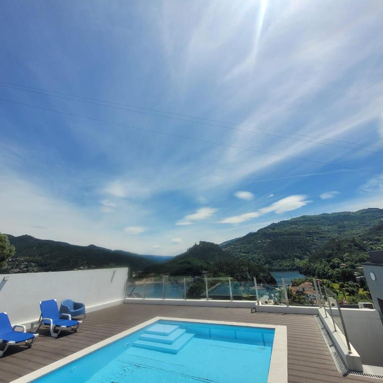 a swimming pool on the roof of a house at Casa da Praia - Gerês in Bicas